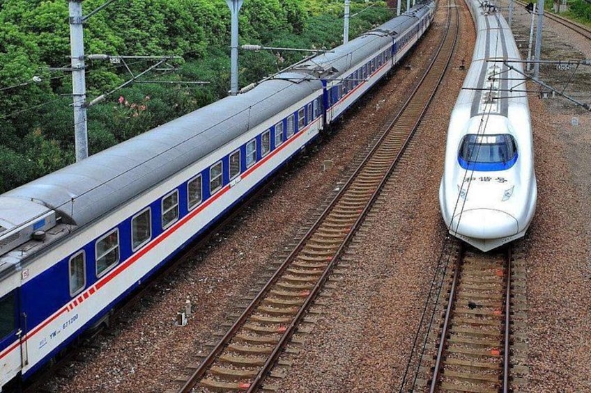 A train on a railway track with another train approaching from the opposite direction. 1
