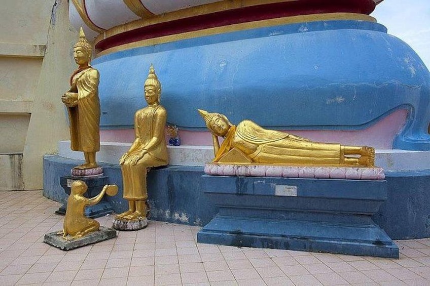 Golden statues of Buddha in various poses, including seated and reclining, on a tiled platform. 5