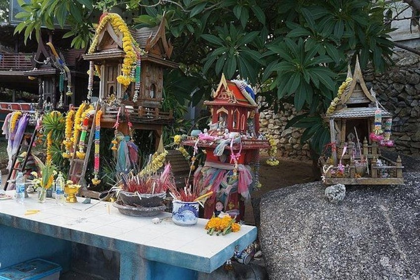 A temple with colorful decorations and offerings. 3