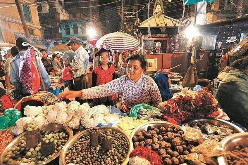 A bustling market with vendors and customers, various food items, and traditional architecture. 3