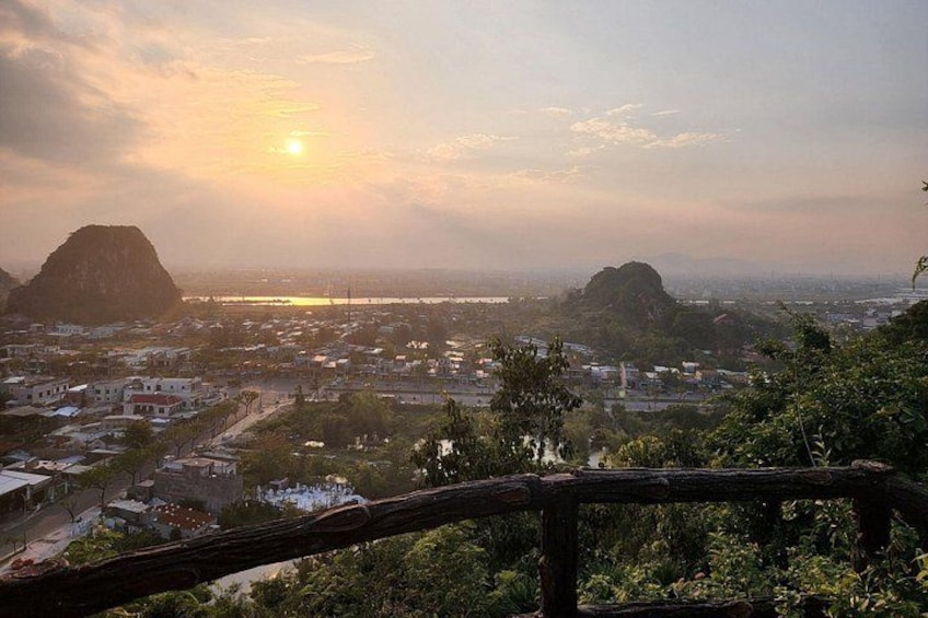 A sunrise over a city with mountains in the background. 4