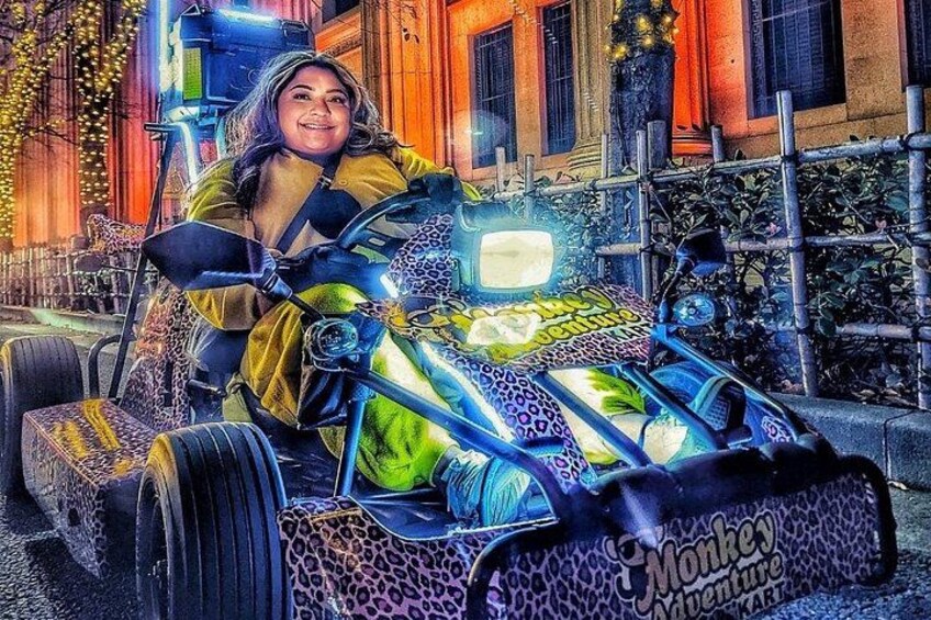 A person driving a uniquely decorated vehicle with a leopard print pattern and a 'Monkey Adventure Kart' label. 3