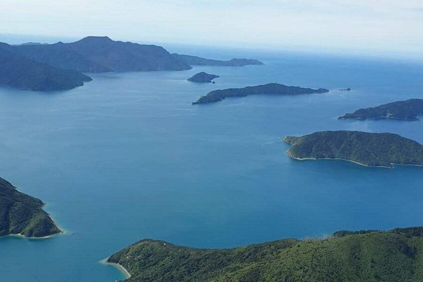A coastal landscape with multiple islands surrounded by calm blue waters. 4