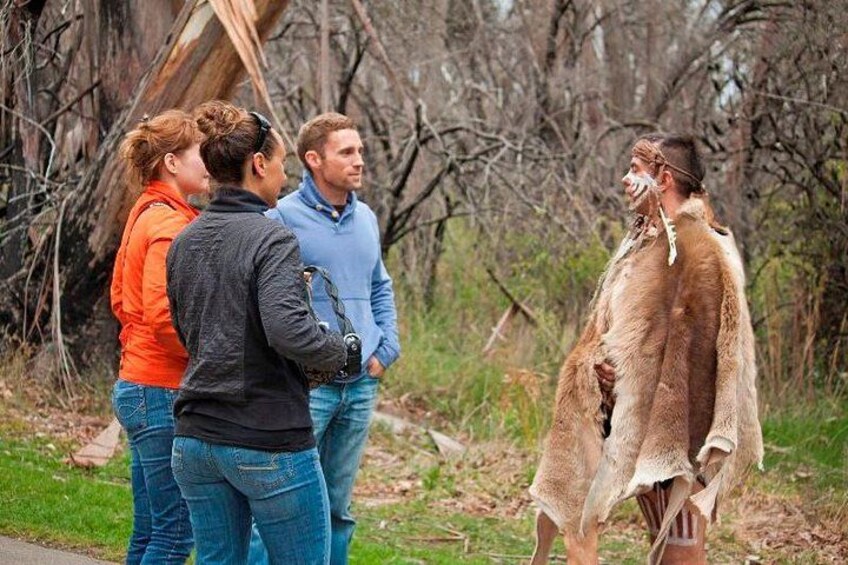 A group of people standing outdoors, one person in a fur coat. 1