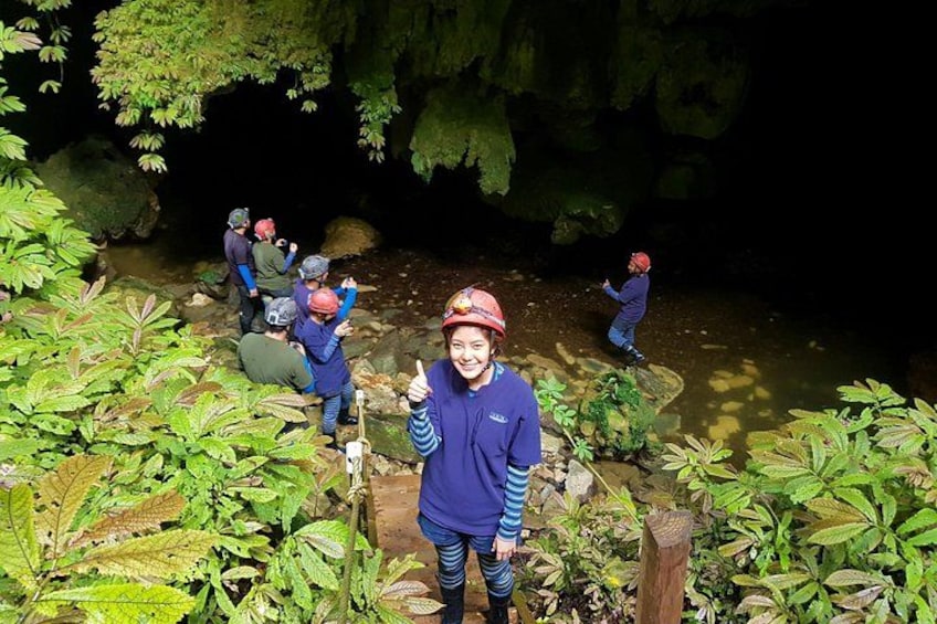 A group of people hiking in a forested area with a stream. 5