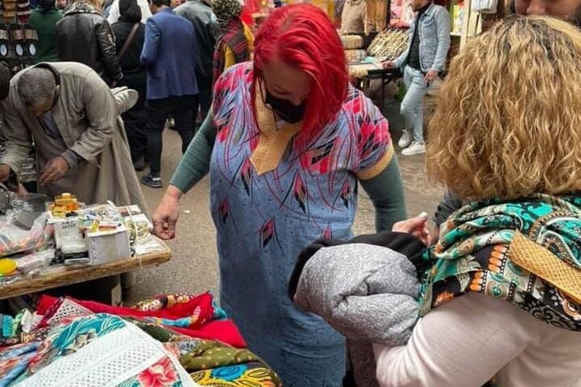 A market scene with people browsing and interacting with vendors. 3
