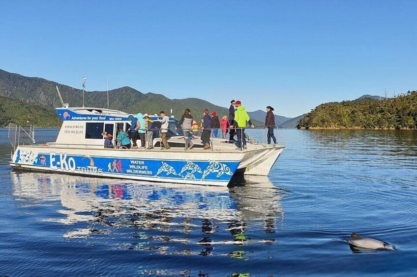 A boat with people on it, surrounded by water and mountains. 5