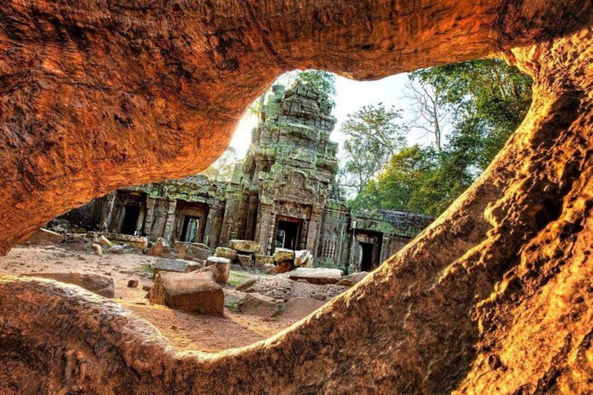 A temple complex with stone structures and a large rock formation. 2