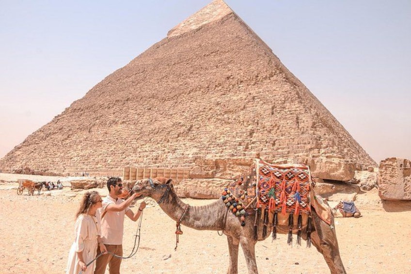 A pyramid, a camel, and two people. 5