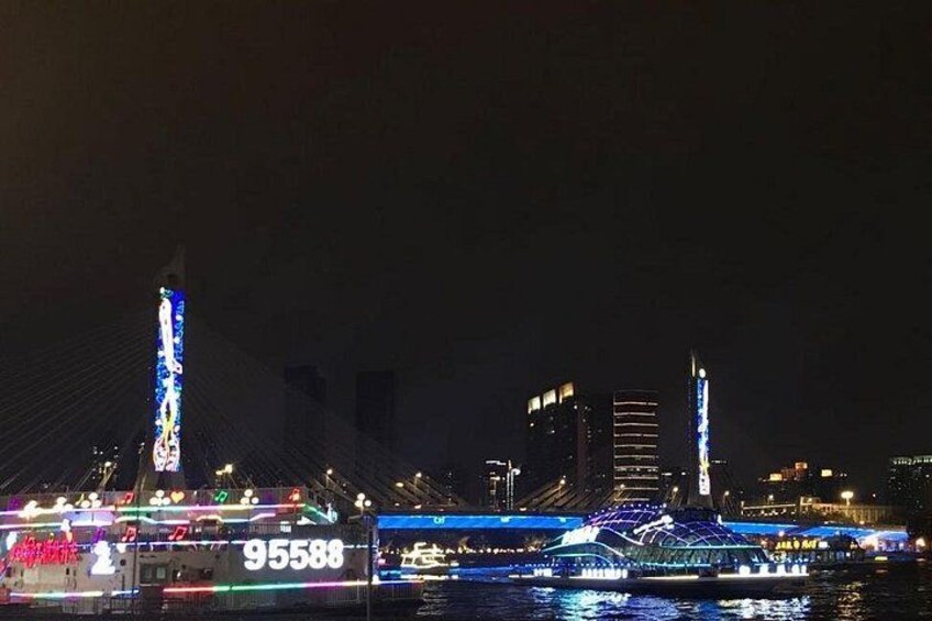 A nighttime cityscape with illuminated buildings and a river. 5