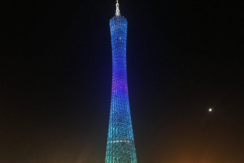 A tall, illuminated tower against a dark sky. 2