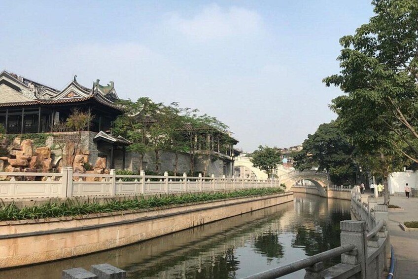 A traditional Chinese building, a canal, and a stone bridge. 1