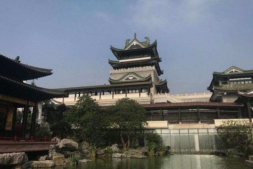 A traditional Chinese building with multiple tiers and a pond in the foreground. 3