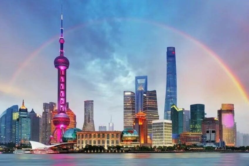 A city skyline with a prominent tower, skyscrapers, and a rainbow. 3