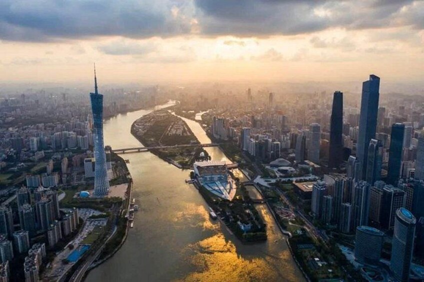 A cityscape with a prominent tower, a river, and surrounding high-rise buildings. 2