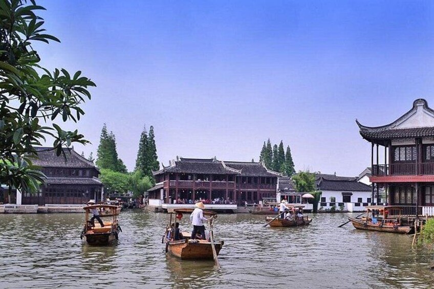 Traditional boats on a calm river, surrounded by historic buildings with classic architecture. 1