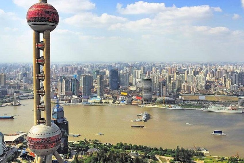 A cityscape with a prominent tower, a river, and a densely packed urban area. 5