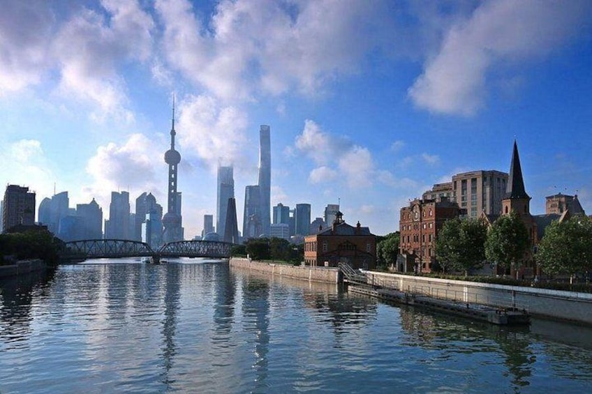 A river with a bridge, a city skyline with modern and historic buildings, and a tower. 3