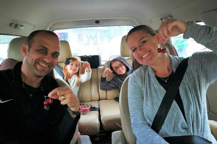 A vehicle interior with four people seated. 2