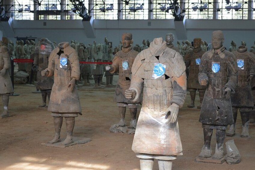 Terracotta soldiers in a museum setting. 5