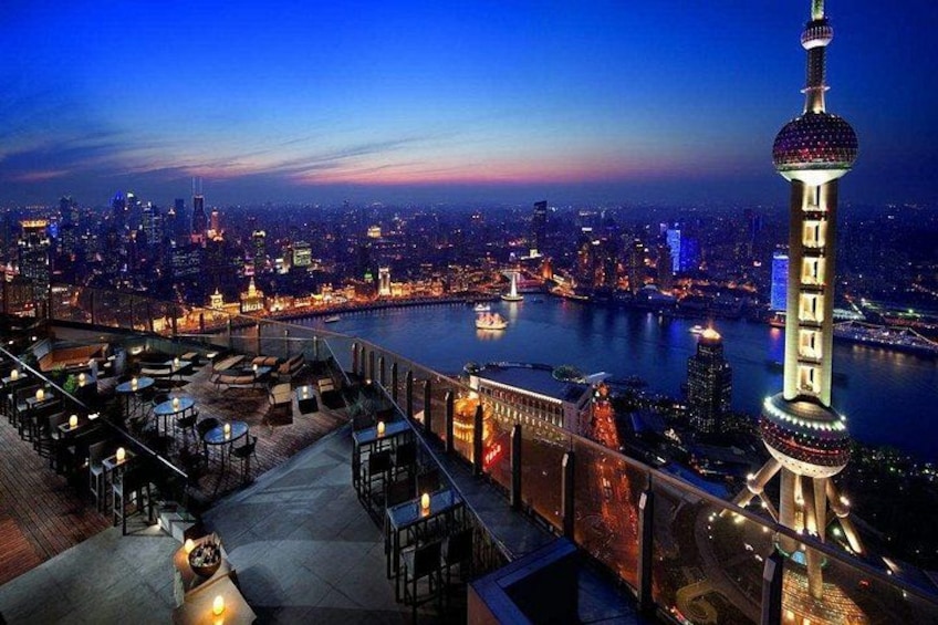 A cityscape at dusk with a prominent tower and a river. 3