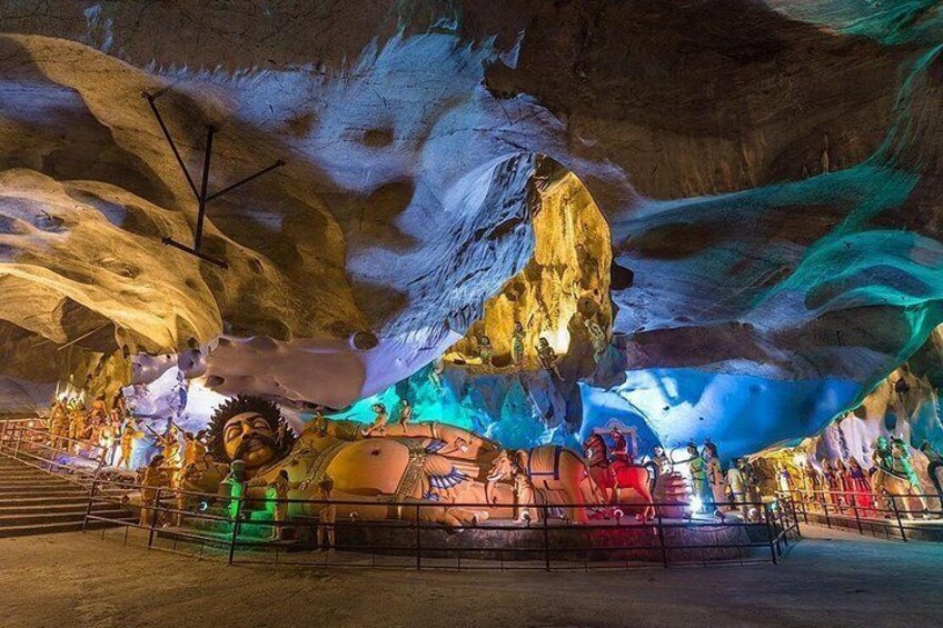 An indoor cave with colorful lighting and rock formations. 5