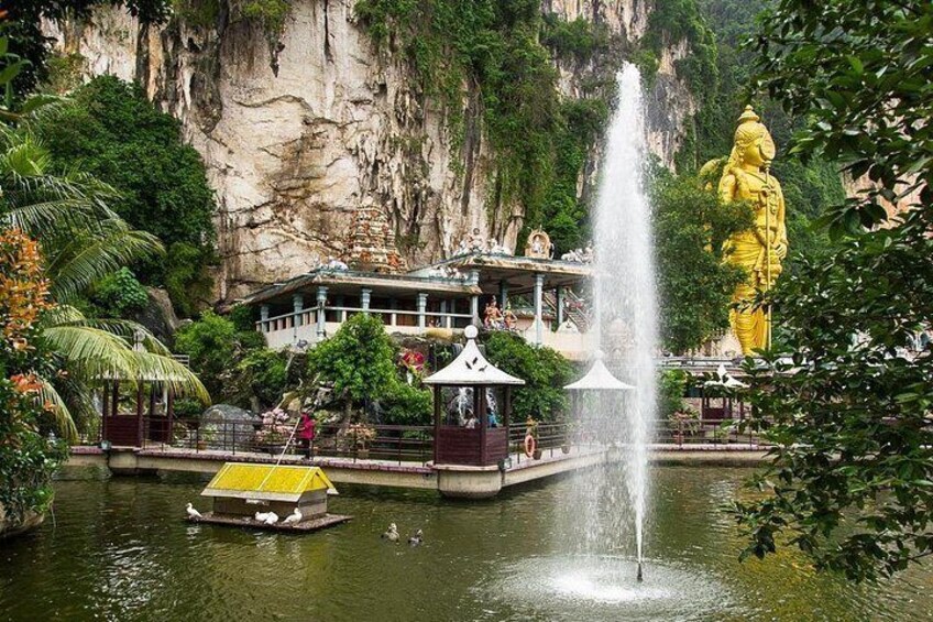 A large golden statue, a fountain, a boat, and a building with a roof. 3