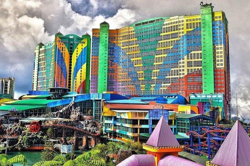 A colorful building with a unique facade, a water park, and a large Ferris wheel. 4