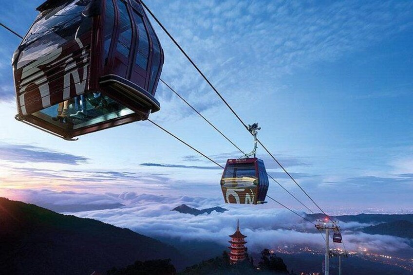 A cable car system with a pagoda in the background. 5