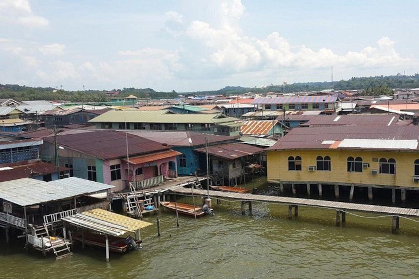A waterfront community with colorful buildings, a dock, and a bridge over the water. 3
