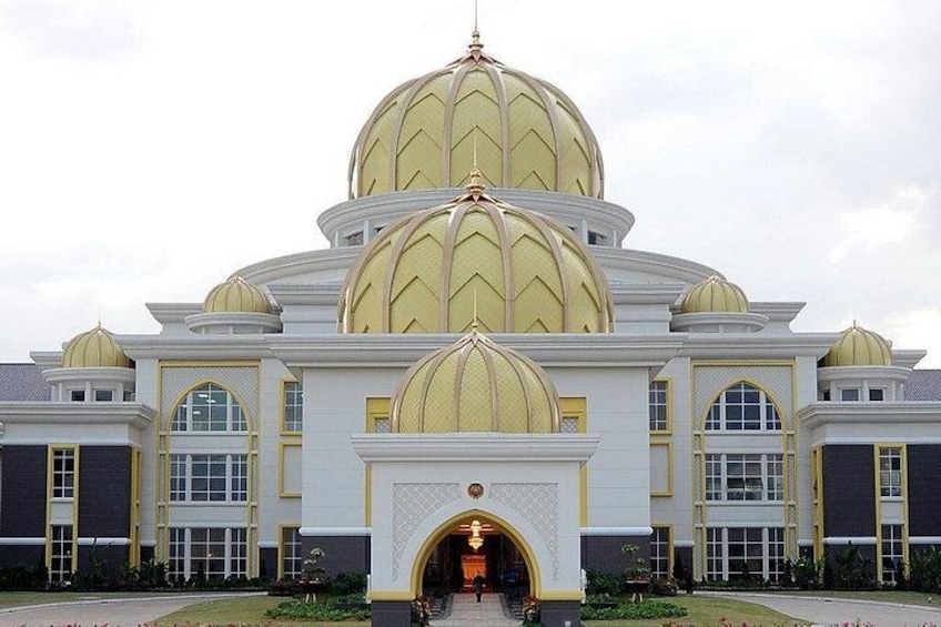 A large building with multiple domes, a prominent entrance, and a well-maintained garden. 4