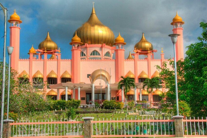 A pink and gold building with multiple domes and minarets. 2