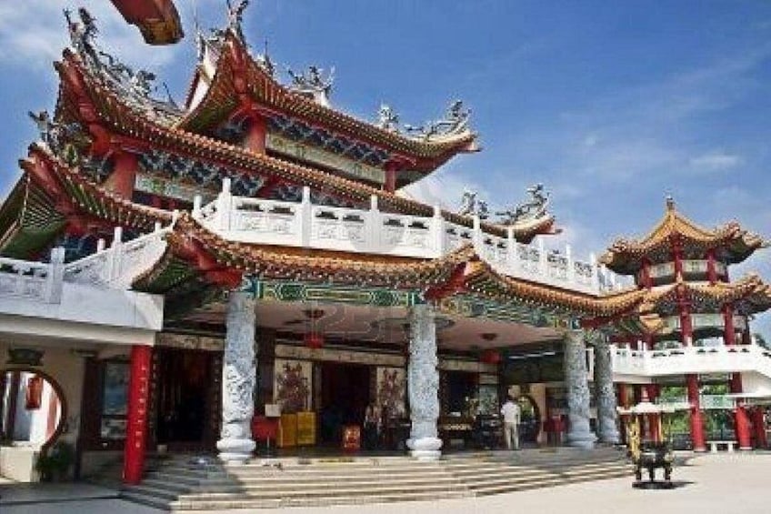 A traditional Chinese temple with ornate architecture, including multi-tiered roofs and intricate carvings. 2
