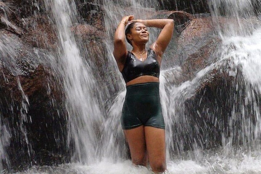 A person standing in front of a waterfall. 5