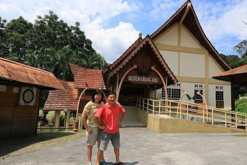 A building labeled 'MUZIUM ORANG ASLI' with a traditional architectural style, a staircase, and a paved entrance area. 5