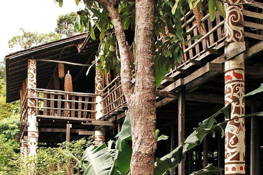 A traditional wooden structure with intricate carvings, surrounded by lush greenery. 3