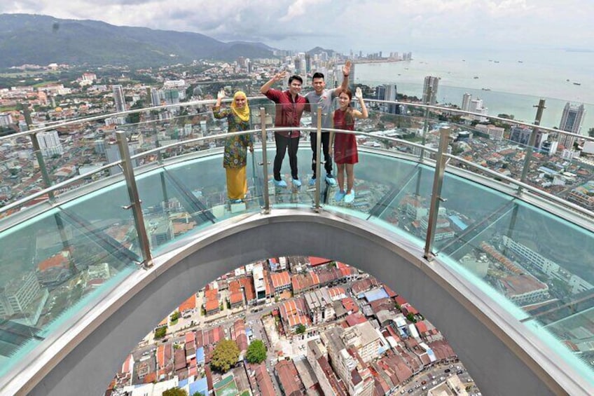 A glass-bottomed viewing platform with a panoramic cityscape view. 2