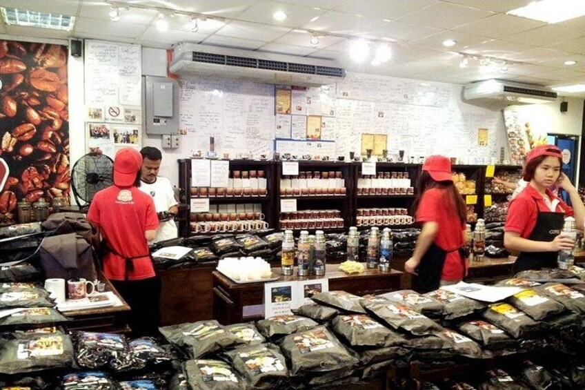 A store with shelves stocked with packaged goods, a fan, and a wall with text and images. 4