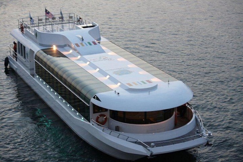 A large, modern cruise ship with a covered deck and multiple levels. 5