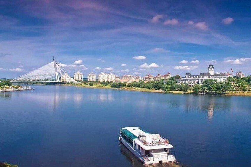 A river with a boat, a bridge, and buildings in the background. 1