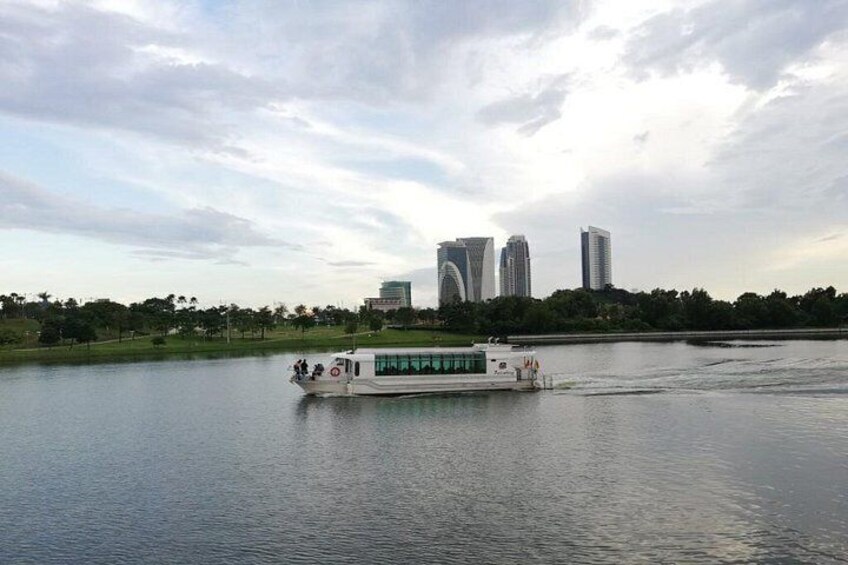 A river with a boat, a city skyline in the background, and a park with trees. 2