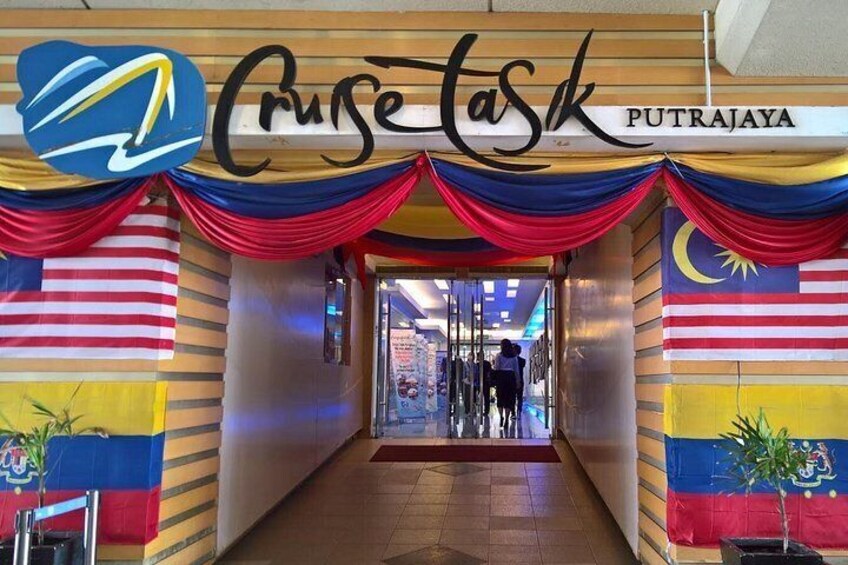 A corridor with a sign reading 'Cruise Task' and Malaysian flags. 5