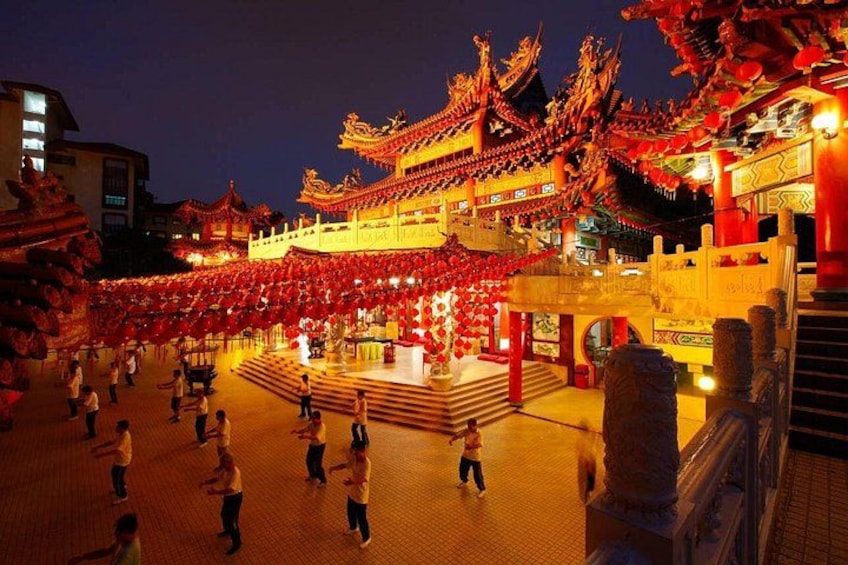 A traditional Chinese building with ornate architecture, a central courtyard, and red lanterns. 2
