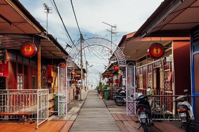 A narrow street with traditional buildings, a bicycle rack, and a scooter parked on the side. 3