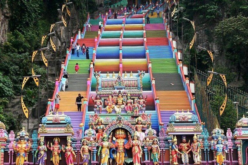 A colorful temple with multiple levels and statues. 3