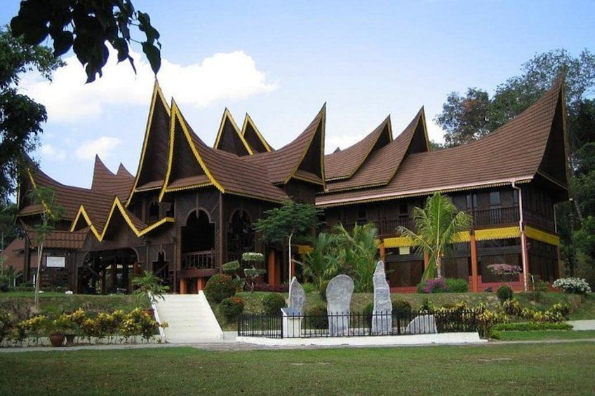 A traditional wooden building with pointed roofs and a well-maintained garden. 4