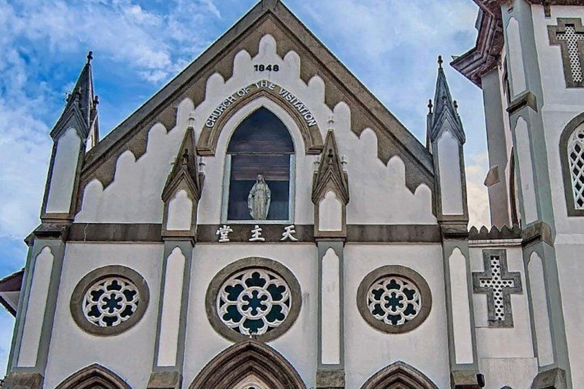 A church with a pointed arch and a cross on the facade. 3