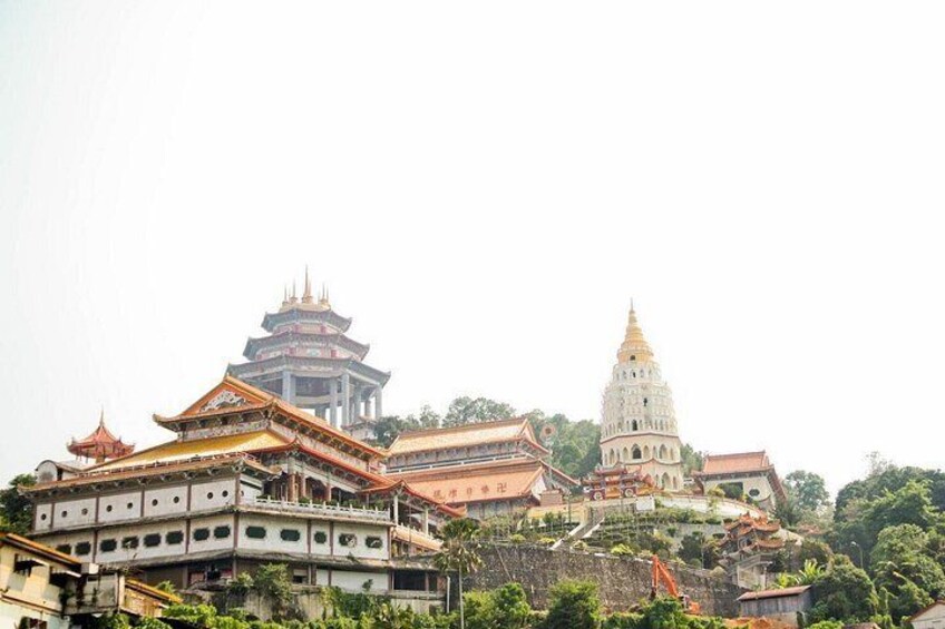 A temple complex with traditional architecture, including tiered roofs and ornate decorations. 5