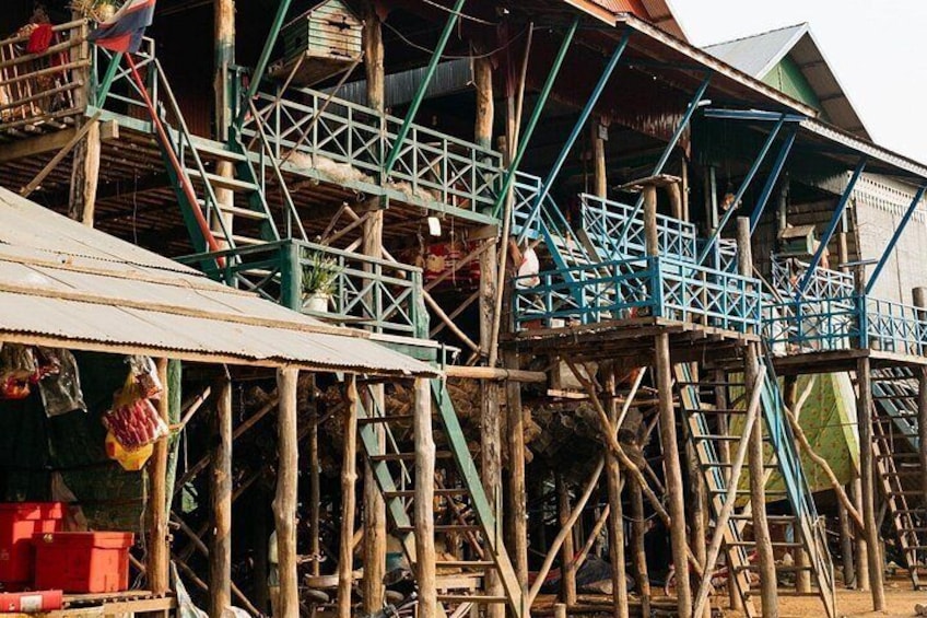 A wooden structure with blue railings and a staircase. 2