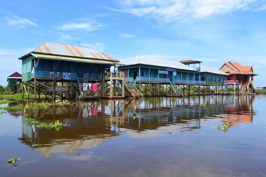 Floating houses on stilts over water with reflections. 3